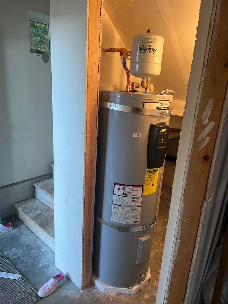 A. O. Smith electric water heater under a staircase with an Amtrol expansion tank
