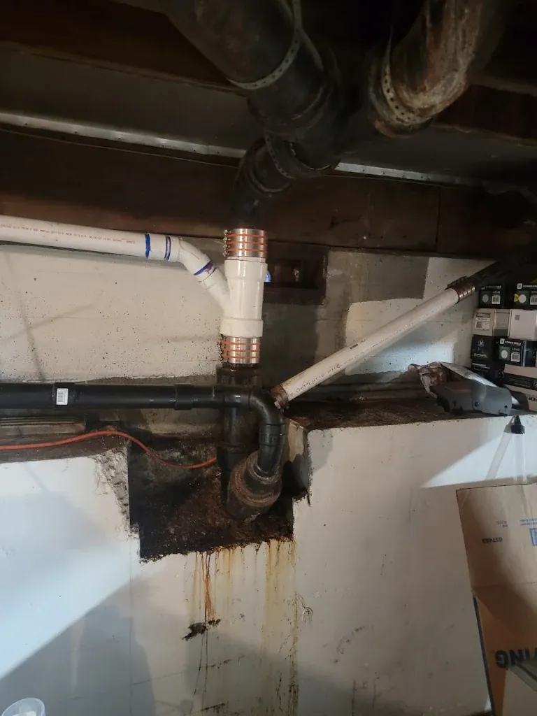 Basement drain repair with old cast iron transitioned to new PVC using shielded couplings