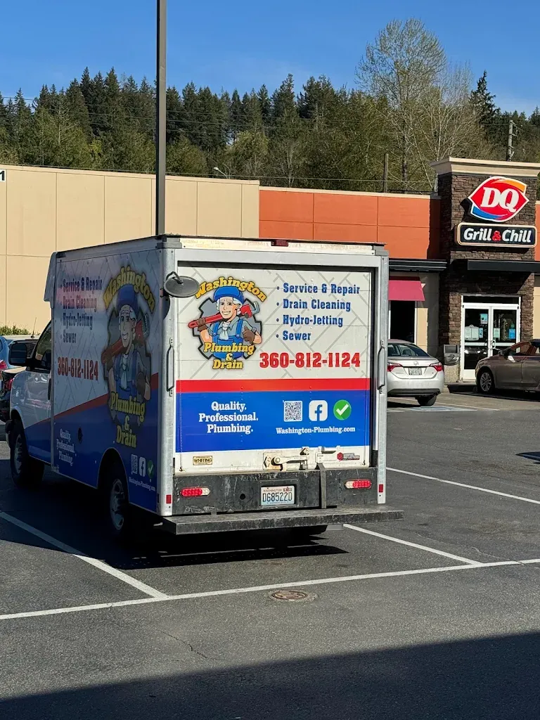 Washington Plumbing & Drain service box truck with logo, phone number and services listed on the rear doors — Emergency Plumbing for Ruston homes