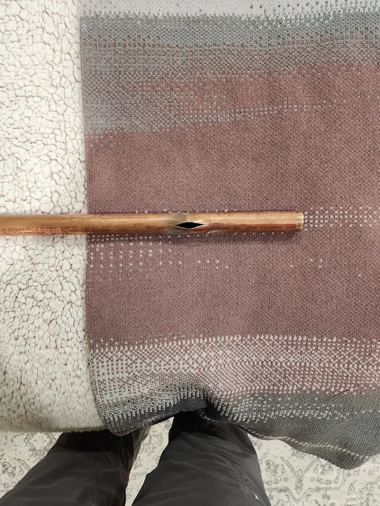 Section of copper pipe split open lengthwise from freezing