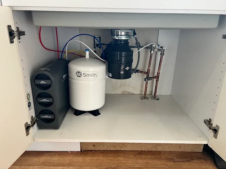 A. O. Smith reverse osmosis system, storage tank and garbage disposal installed under a kitchen sink — Garbage Disposal Repair & Installation for Allyn homes