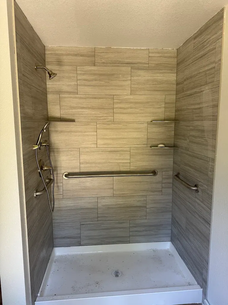 Walk-in tile shower with rain head, handheld, corner shelves and grab bars — Bathroom Remodel Plumbing for Grapeview homes