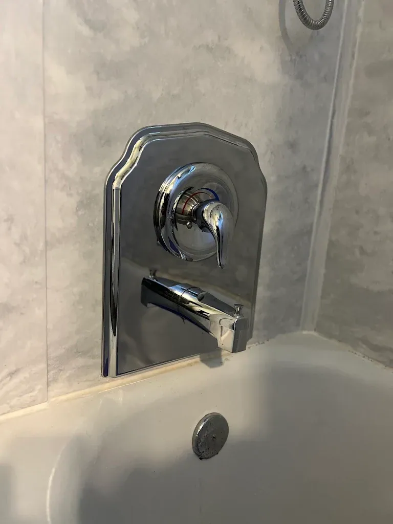 Chrome single-handle tub and shower valve trim with tub spout — Shower Valve & Tub Repair for Fircrest homes